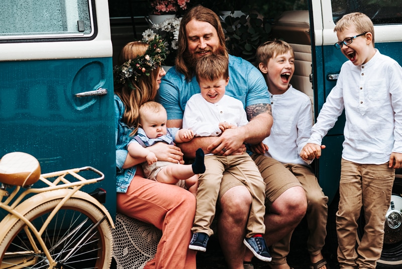 Seattle Motherhood Photography, a family sit within a Volkswagen bus, mom, dad and their four sons
