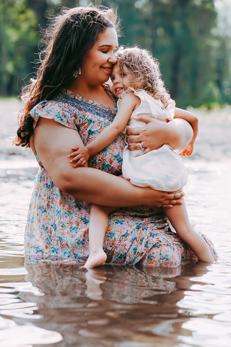 Seattle Maternity Photography, pregnant mother holds her toddler daughter while wading in a quiet river