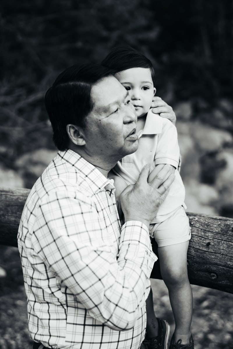 Seattle Grandparent Legacy Photography, grandpa holds his young grandson close outdoors