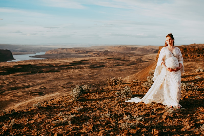 Seattle Maternity Photography, an expecting woman walks through a dry hillside in a white dress
