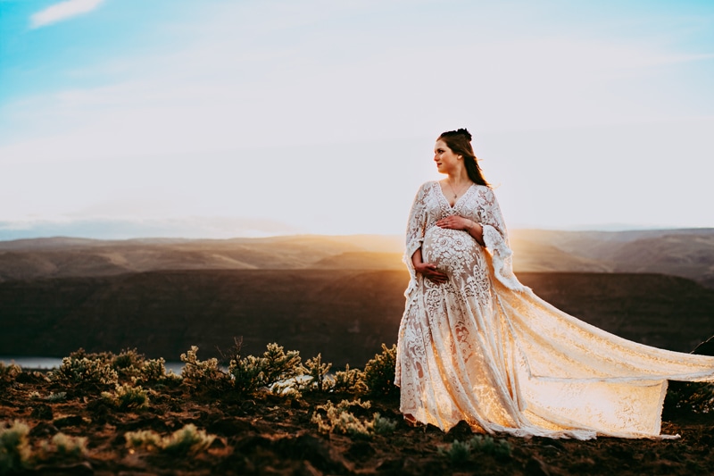 Seattle Maternity Photography, a pregnant woman holds her belly outdoors in nature