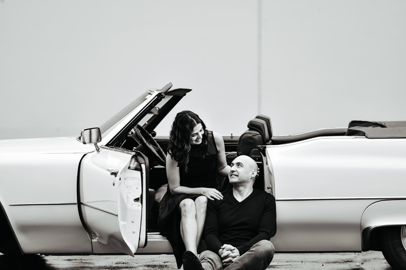 Seattle Couples Photography, Couple sit at their convertible smiling at each other, the woman sits in the driver's seat,