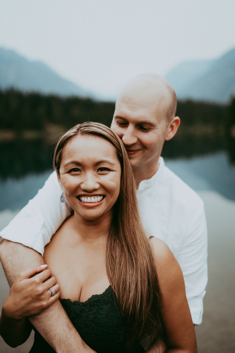 Seattle Couples Photography, a man wraps his arms around his smiling wife
